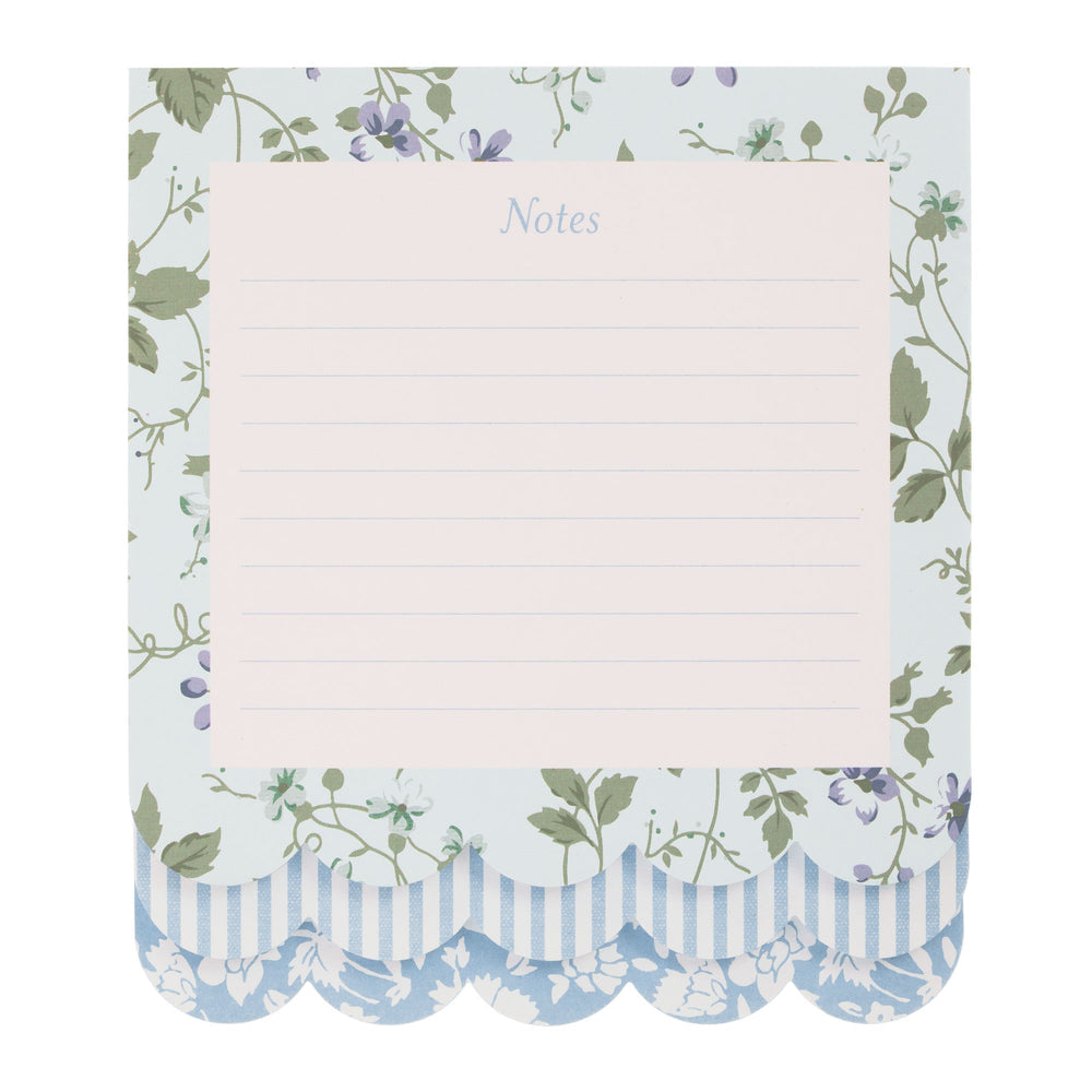 Floral-patterned notepad with a blue lined sheet on a white background