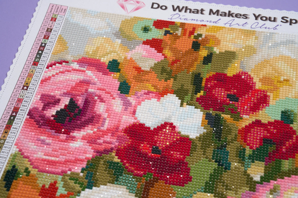 Floral diamond art kit with a partially completed design on a purple background