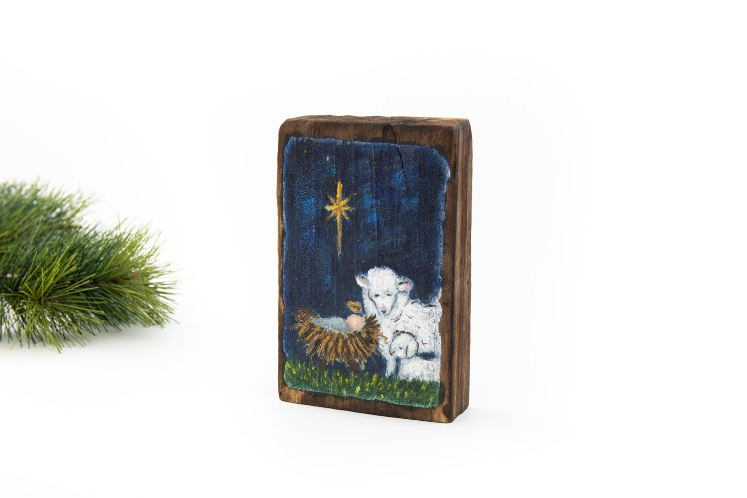 manger scene block art shown on a white background with a sprig of greenery.