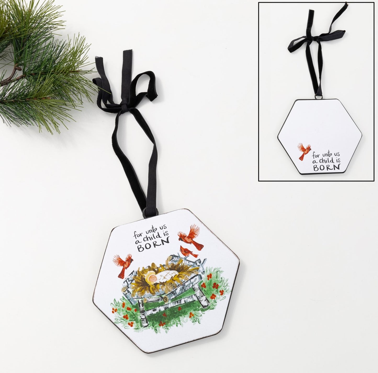 hexagon manger ornament shown with a sprig of greenery and the back view of the ornament in an inset in the corner.