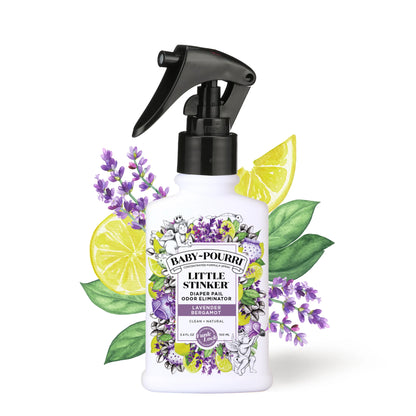 bottle of little stinker spray with a floral and citrus label and artwork of lavender and lemons behind it.