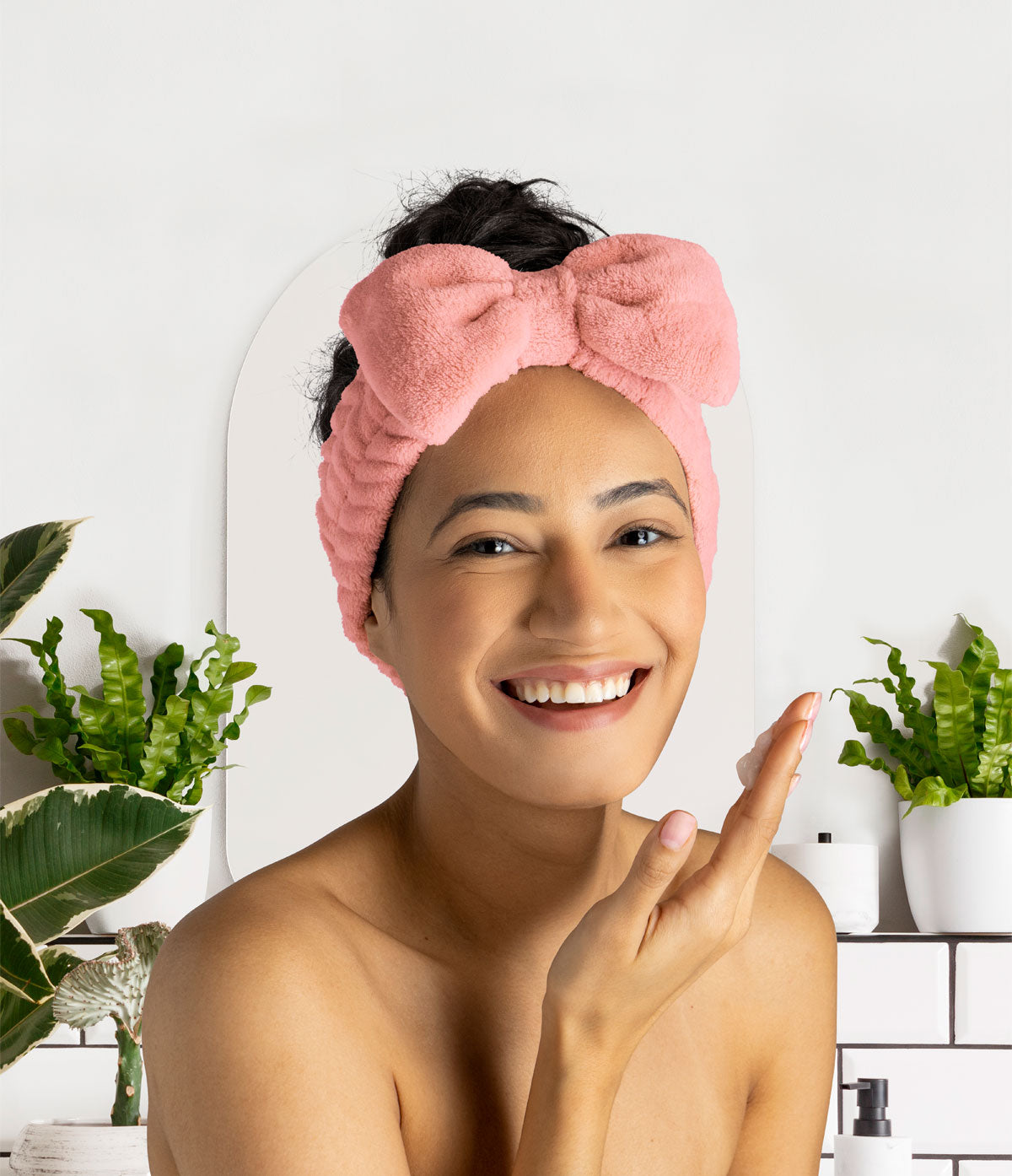 smiling person wearing pink Take A Bow Headband