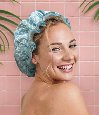 a woman looking over her shoulder in the shower while wearing the Shower Caps 2nd Generation