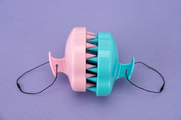 one pink and one blue Love Your Locks Wet & Dry Scalp Massager displayed against a purple background