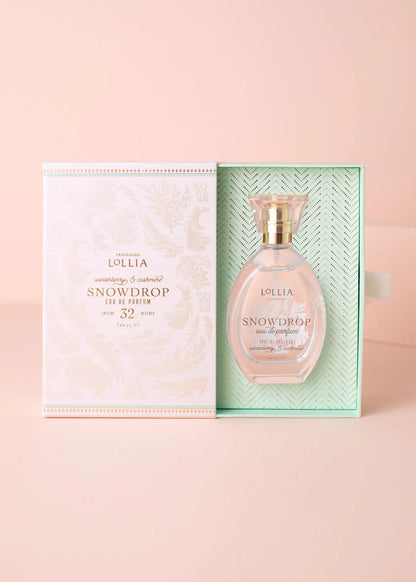Lollia Snowdrop perfume bottle with packaging on a pink background