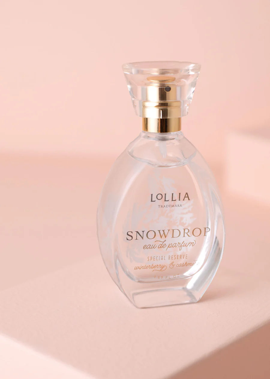 Lollia Snowdrop eau de parfum bottle on a pink background