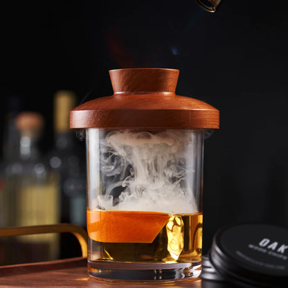 beverage in low ball glass with wooden lid being smoked