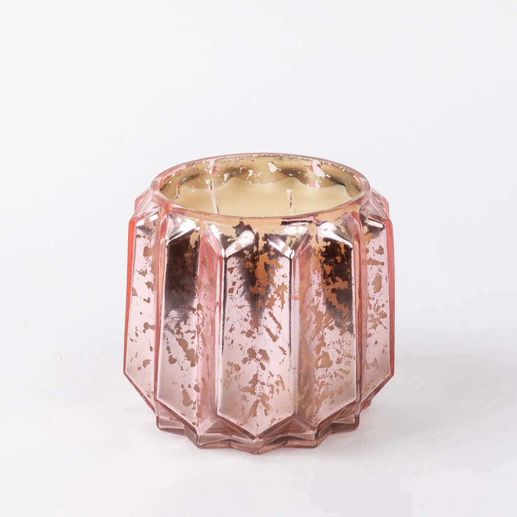Rose gold faceted candle on a white background