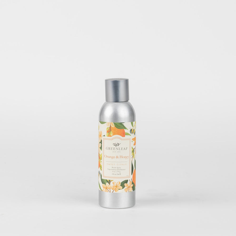 Orange & Honey Room Spray in a silver bottle with label printed with oranges and orange blossoms.