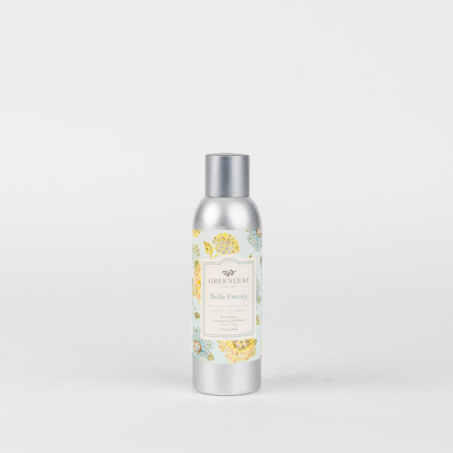 Bella Freesia Room Spray in a silver bottle with a label that is printed with blue and yellow flowers.