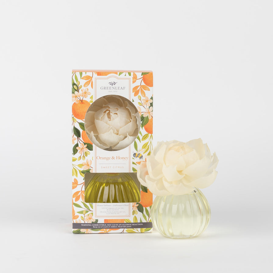 Orange & Honey Flower Diffuser set next to it's box packaging that is printed with oranges and orange blossoms.