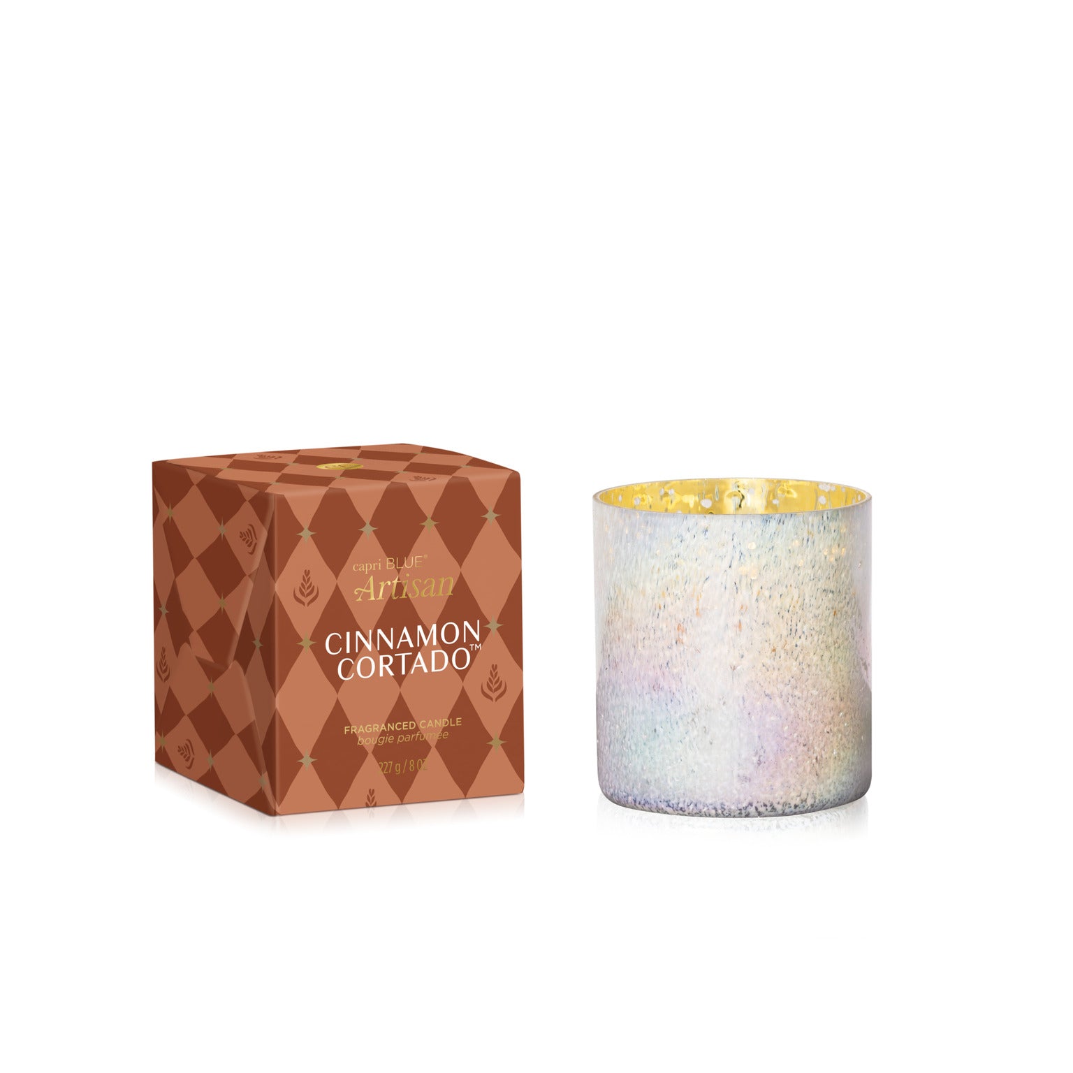 Cinnamon Cortado Artisan Winter Bazaar Tumbler Candle in a white shimmery glass vessel next to its box