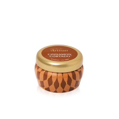 angled view of the Cinnamon Cortado Artisan Winter Bazaar Mini Tin Candle with its lid on 