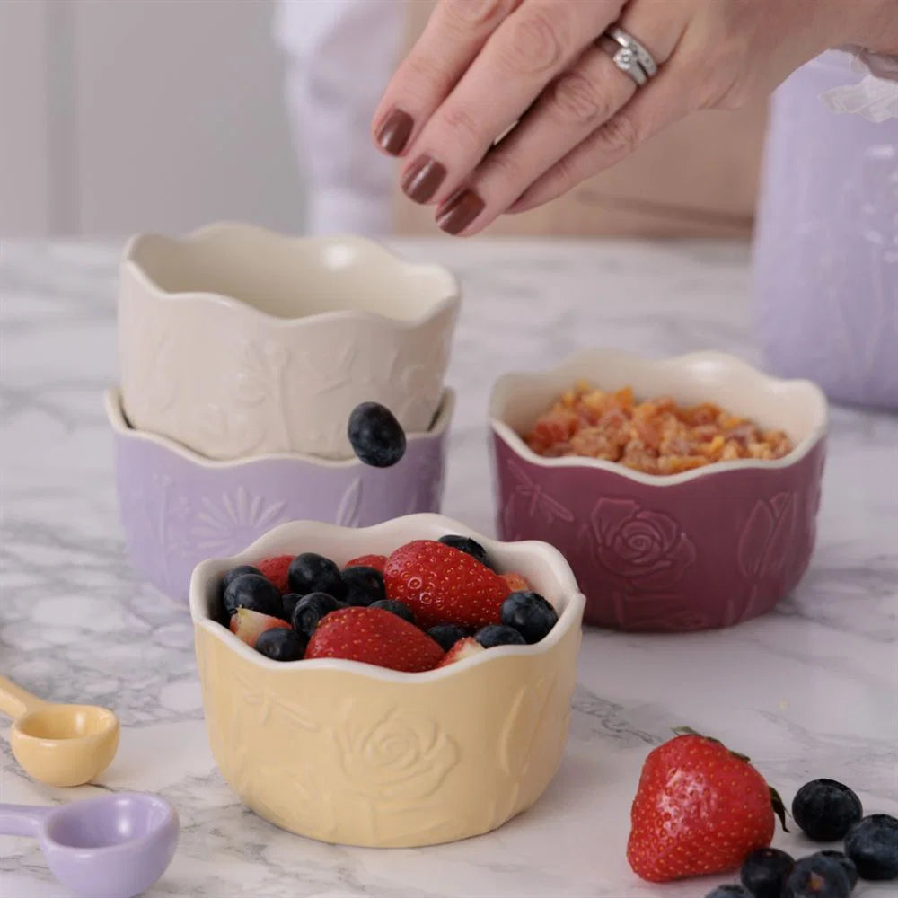 Decorative ceramic ramekins with fruit on a marble surface