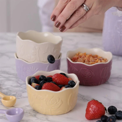 Decorative ceramic ramekins with fruit on a marble surface