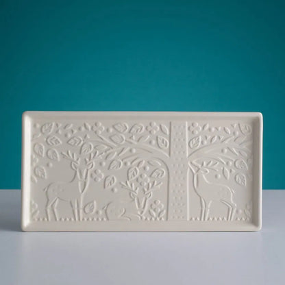 in the forest platter embossed with forest scene shown on a dark teal background