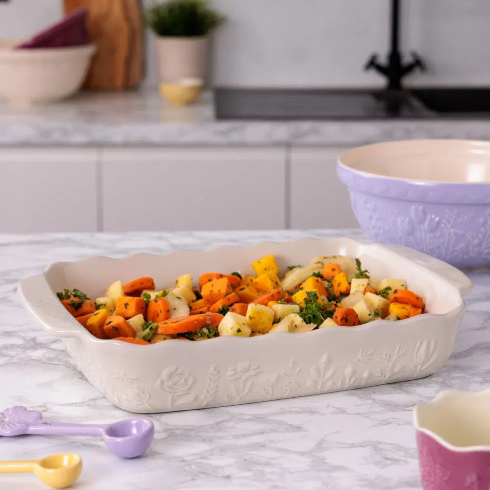 Rectangular baking dish with pasta and vegetables in it on a kitchen counter