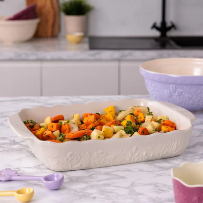Rectangular baking dish with pasta and vegetables in it on a kitchen counter
