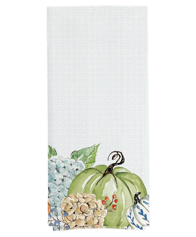 tea towel with pale blue pattern and image on a green pumpkin set among hydrangeas and red berries