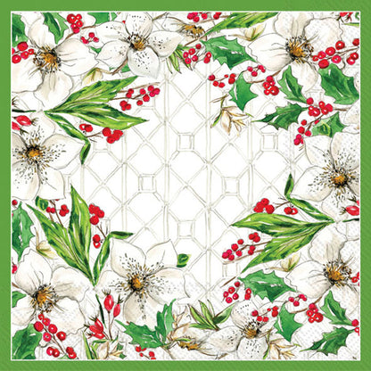 Decorative paper napkin with floral design featuring white flowers, green leaves, and red berries on a geometric patterned background.