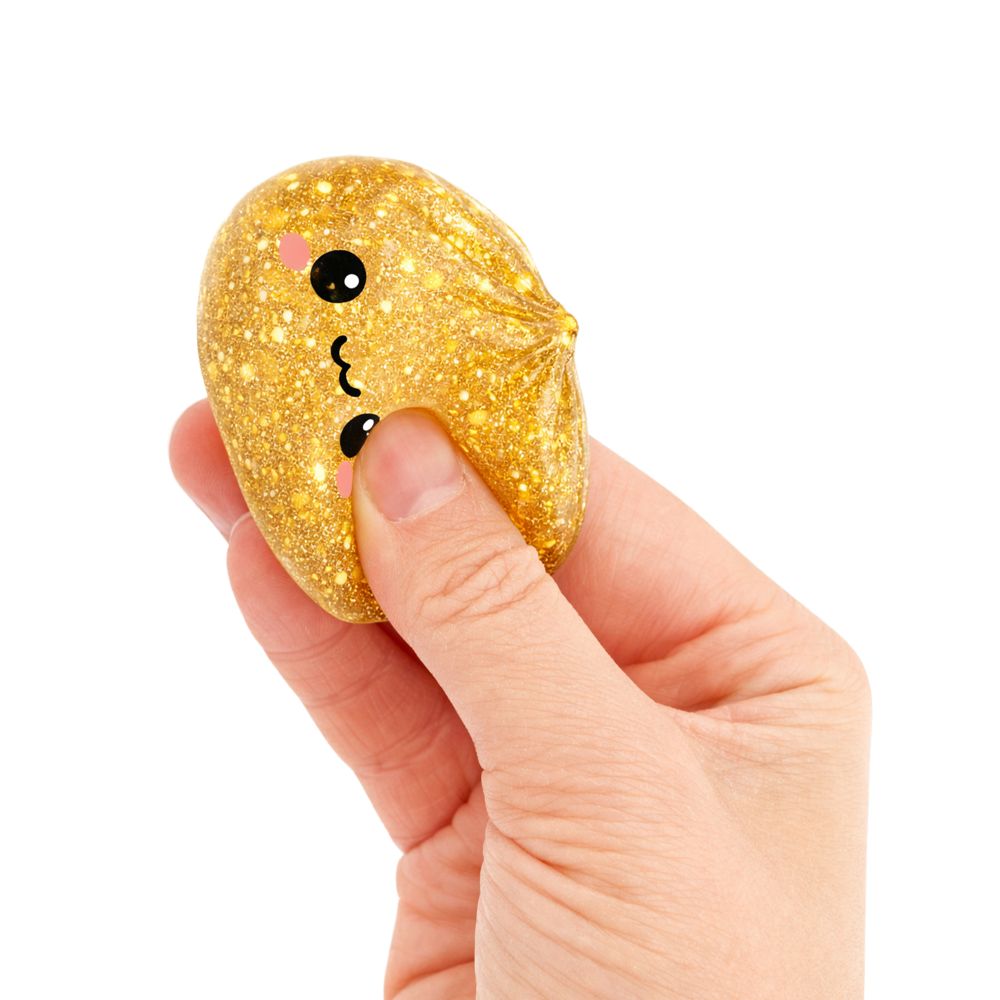 mini gold bao squishy being held by a hand