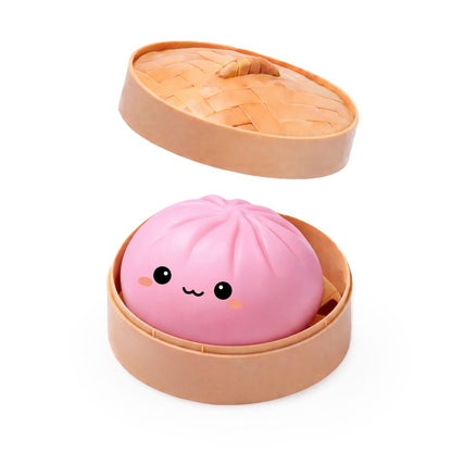 a pink bao in is bamboo like steamer container
