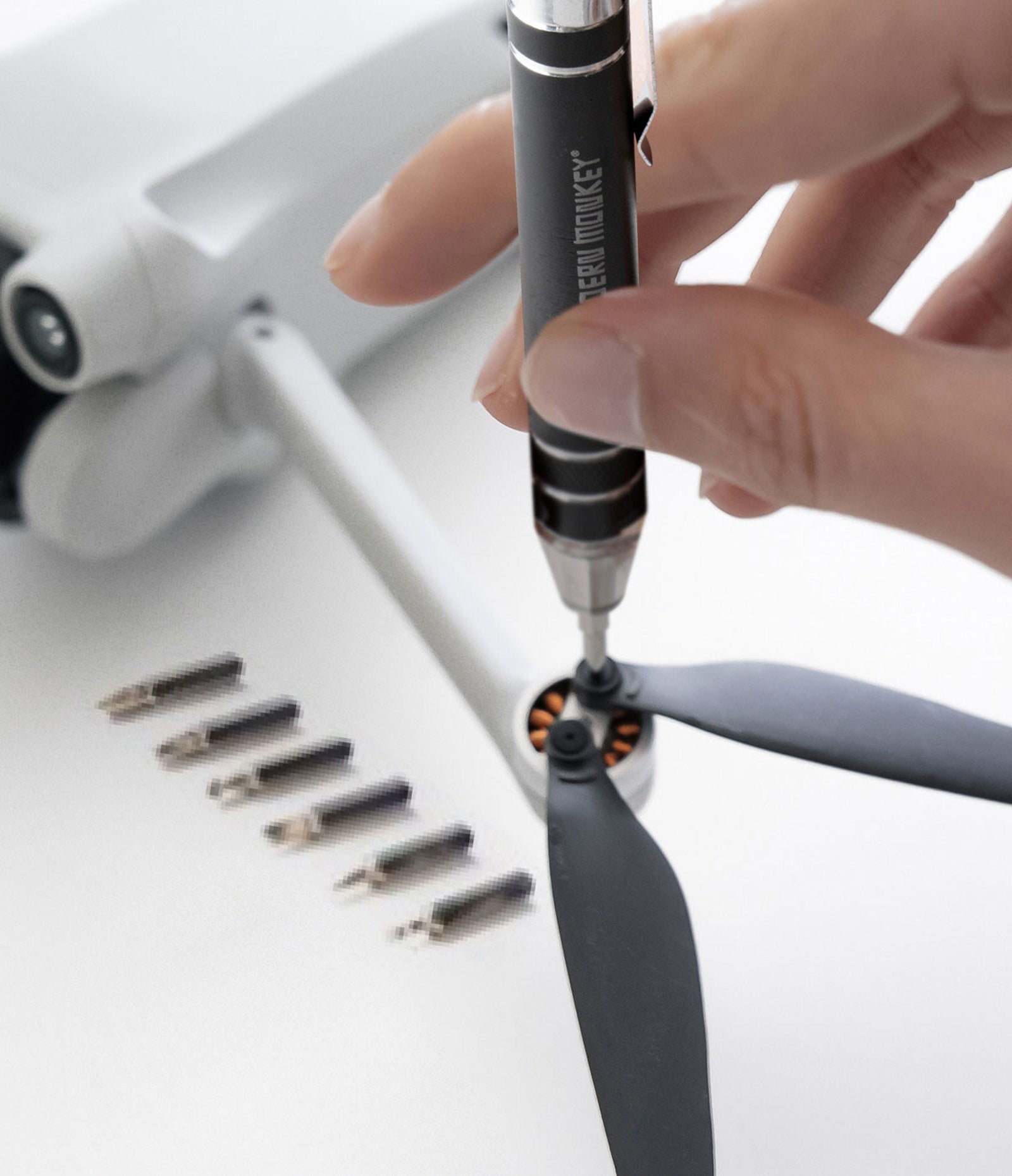 hand using  to tighten small screws