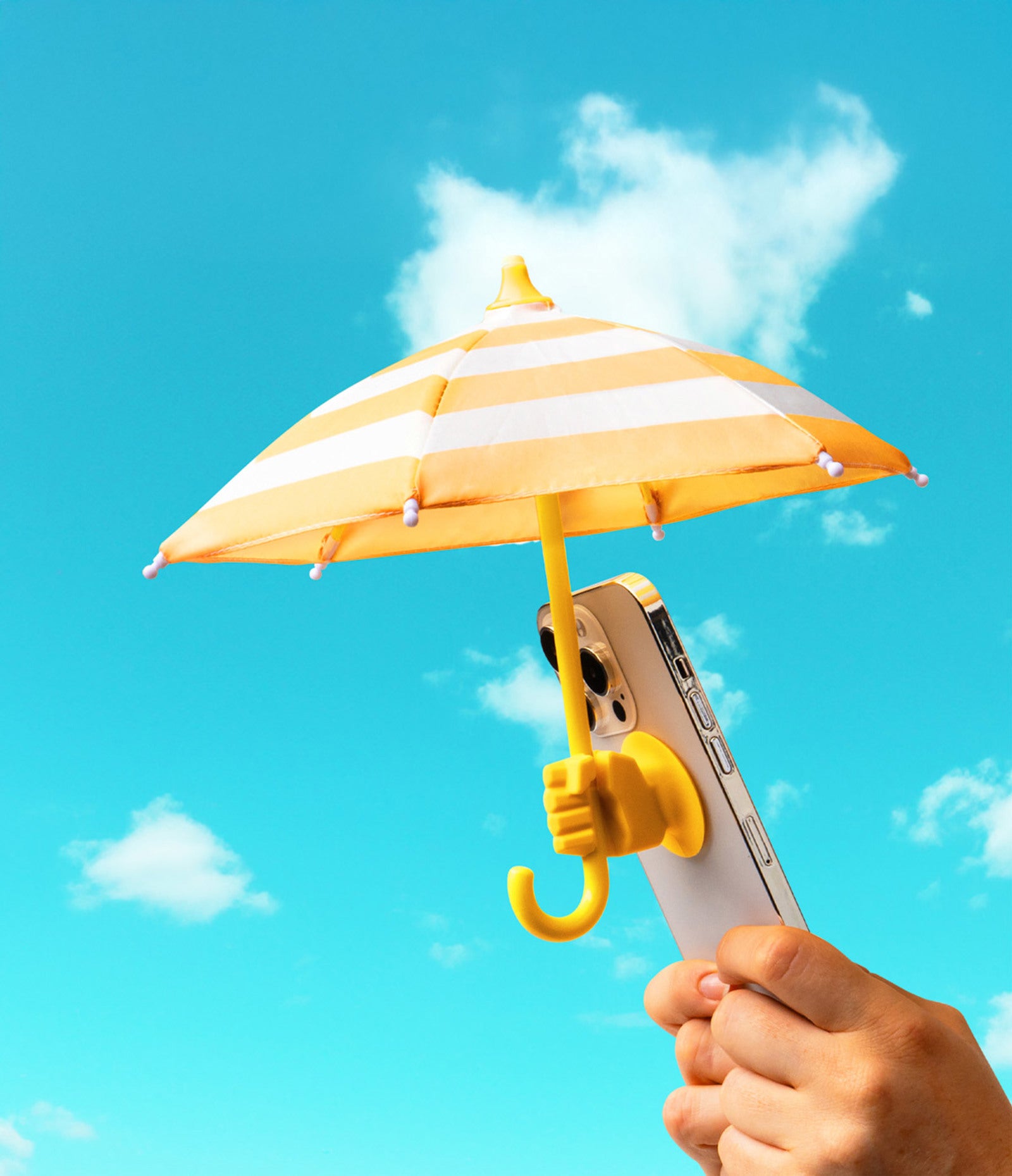 hands holding phone with yellow Cabana Boy Phone Umbrella on a bright sunny day