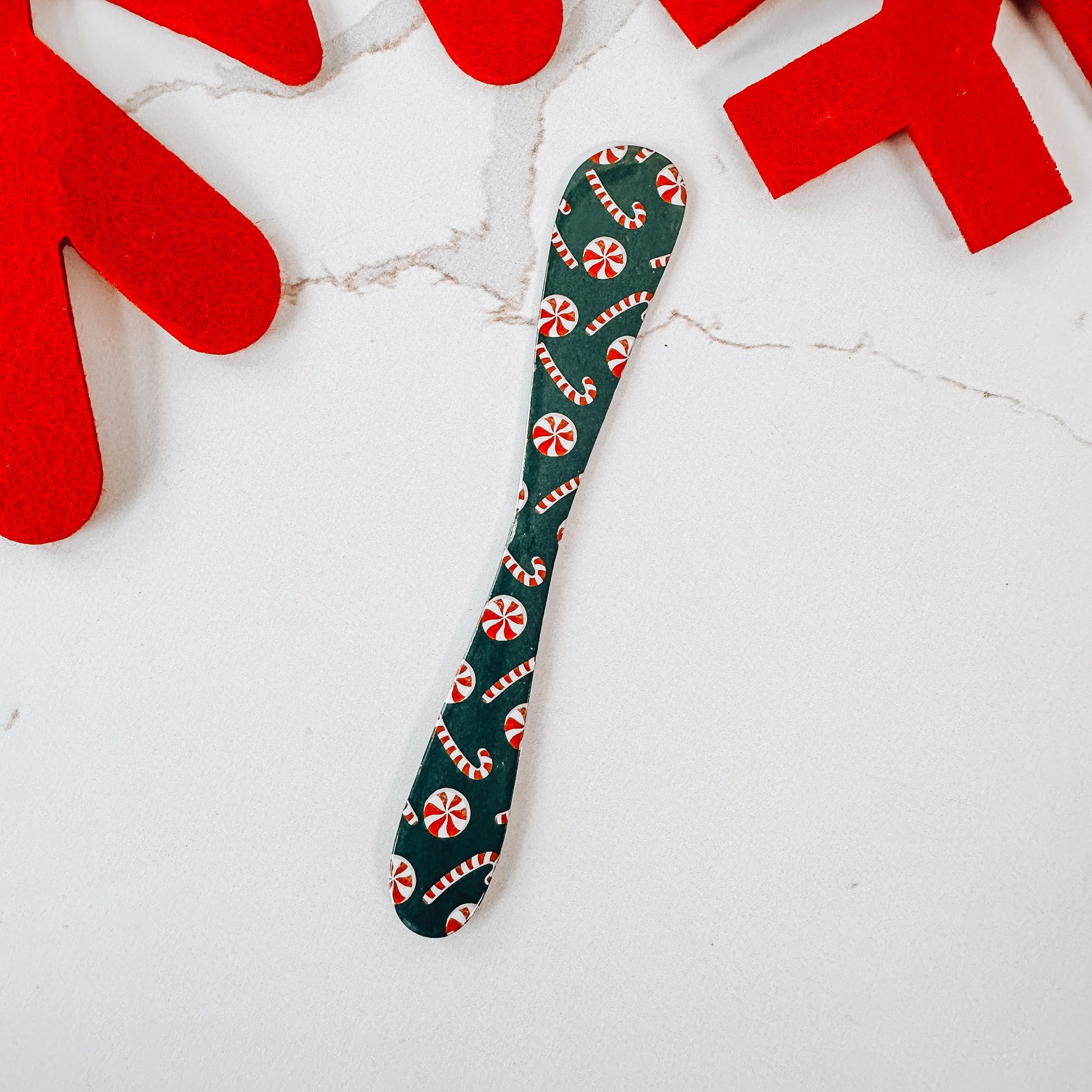 Green spreader with red and white candy canes all over.