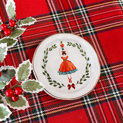 Tidbit dish with a dancer/ballerina holding a nutcracker above her head.