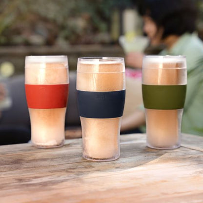 3 colors of beer freeze glasses set on a wooden table.