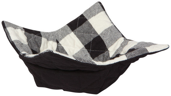 side view of the black and white checked bowl cozy on a white background