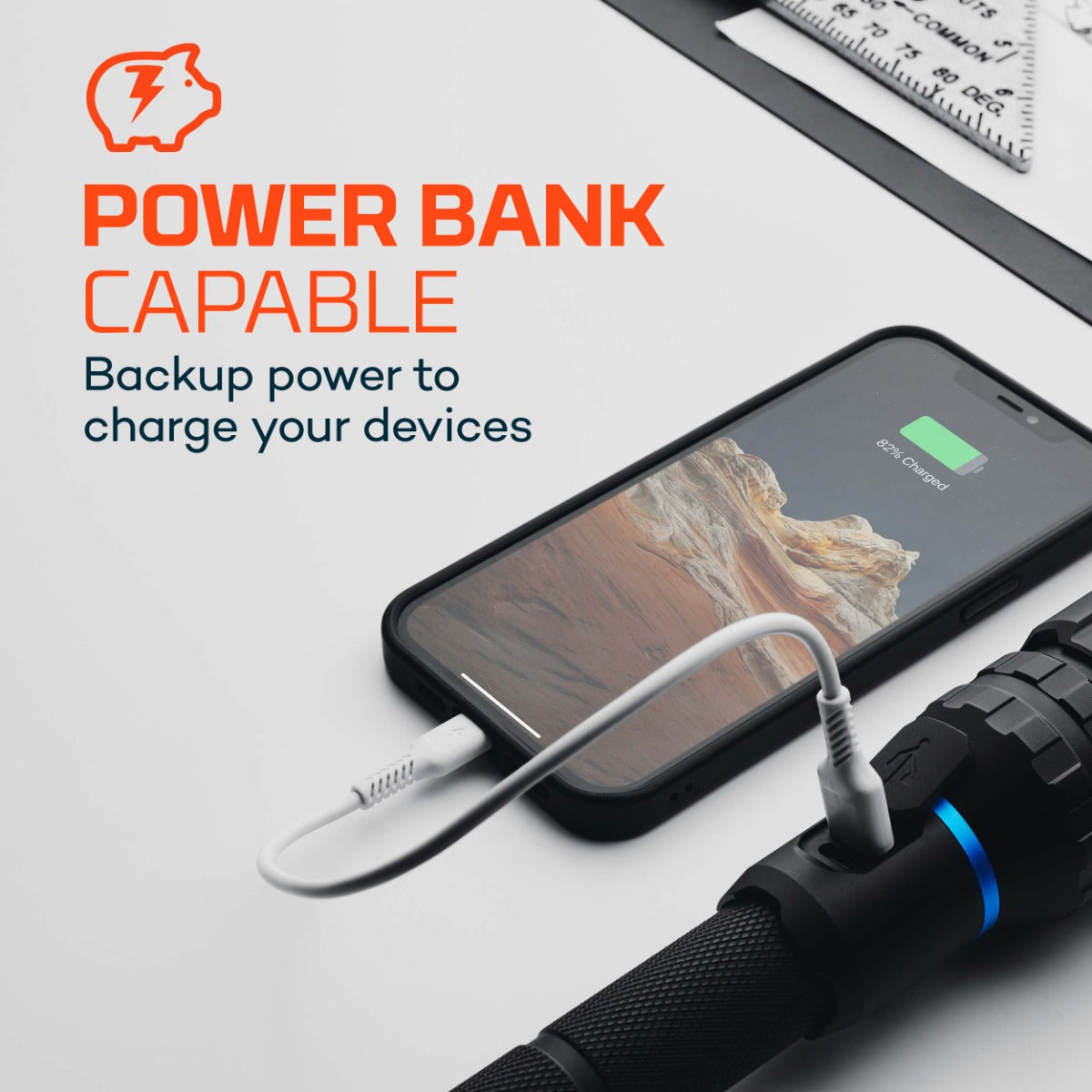 Phone with power bank cable connected to flashlight and text 'Power Bank Capable' on a white background
