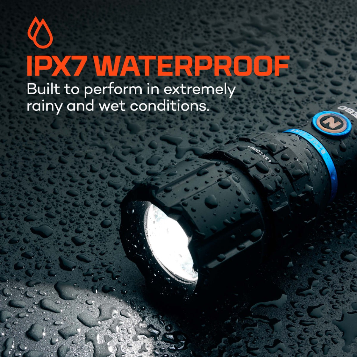 Black flashlight on a wet surface with IPX7 waterproof text