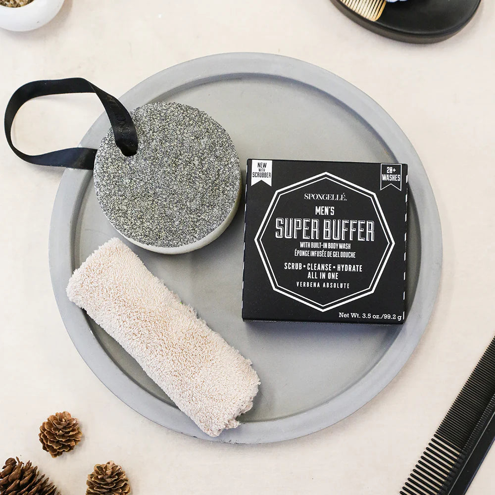 Men's grooming products including a super buffer and scrub on a tray with decorative elements.