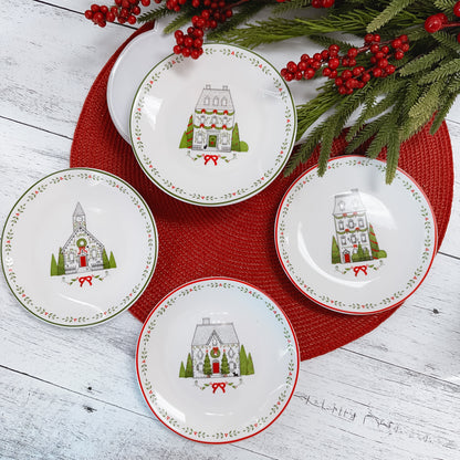 four line drawn red, black, and green ceramic plates on a round red placemat set atop a wooden table.