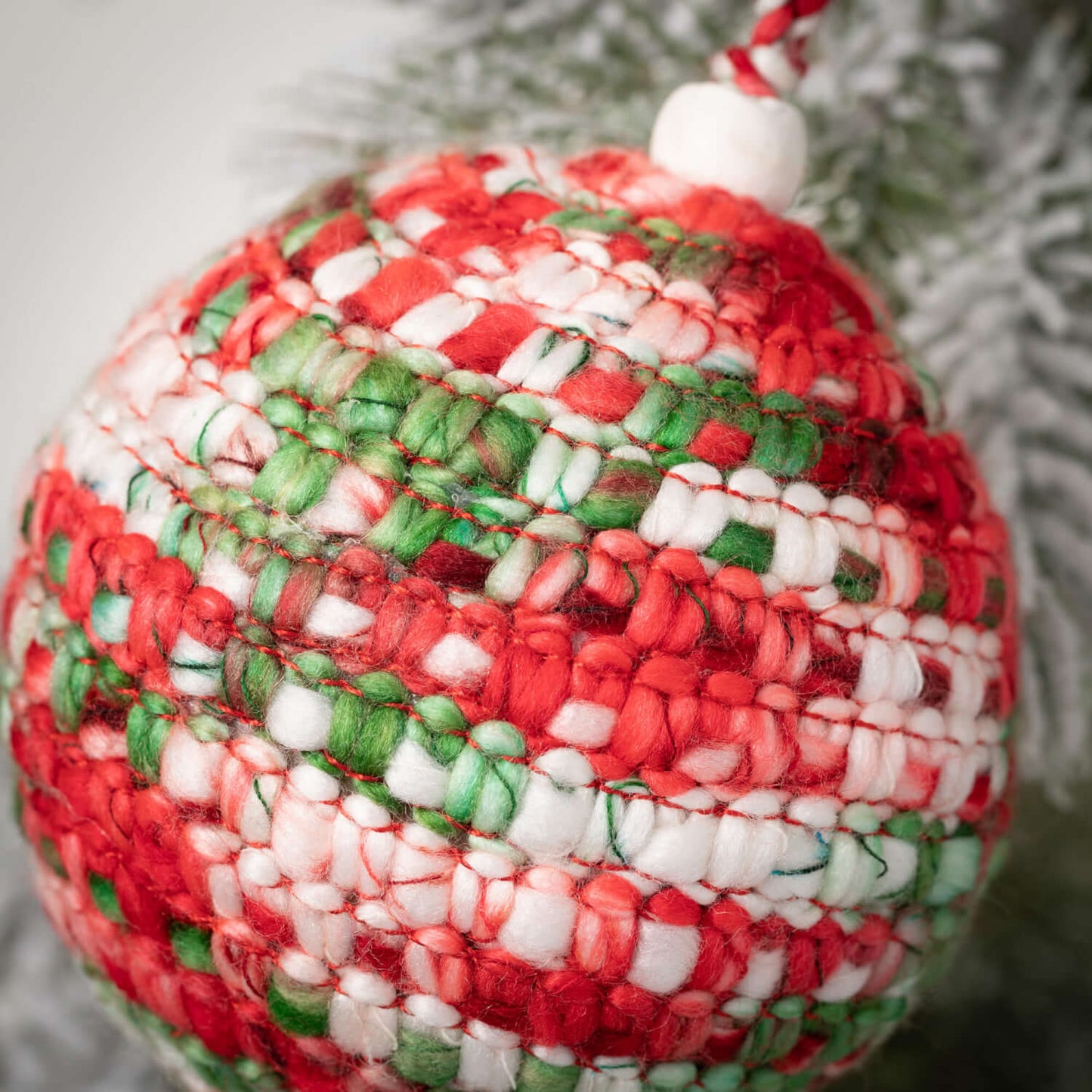 close up view of the festive knit ball ornament