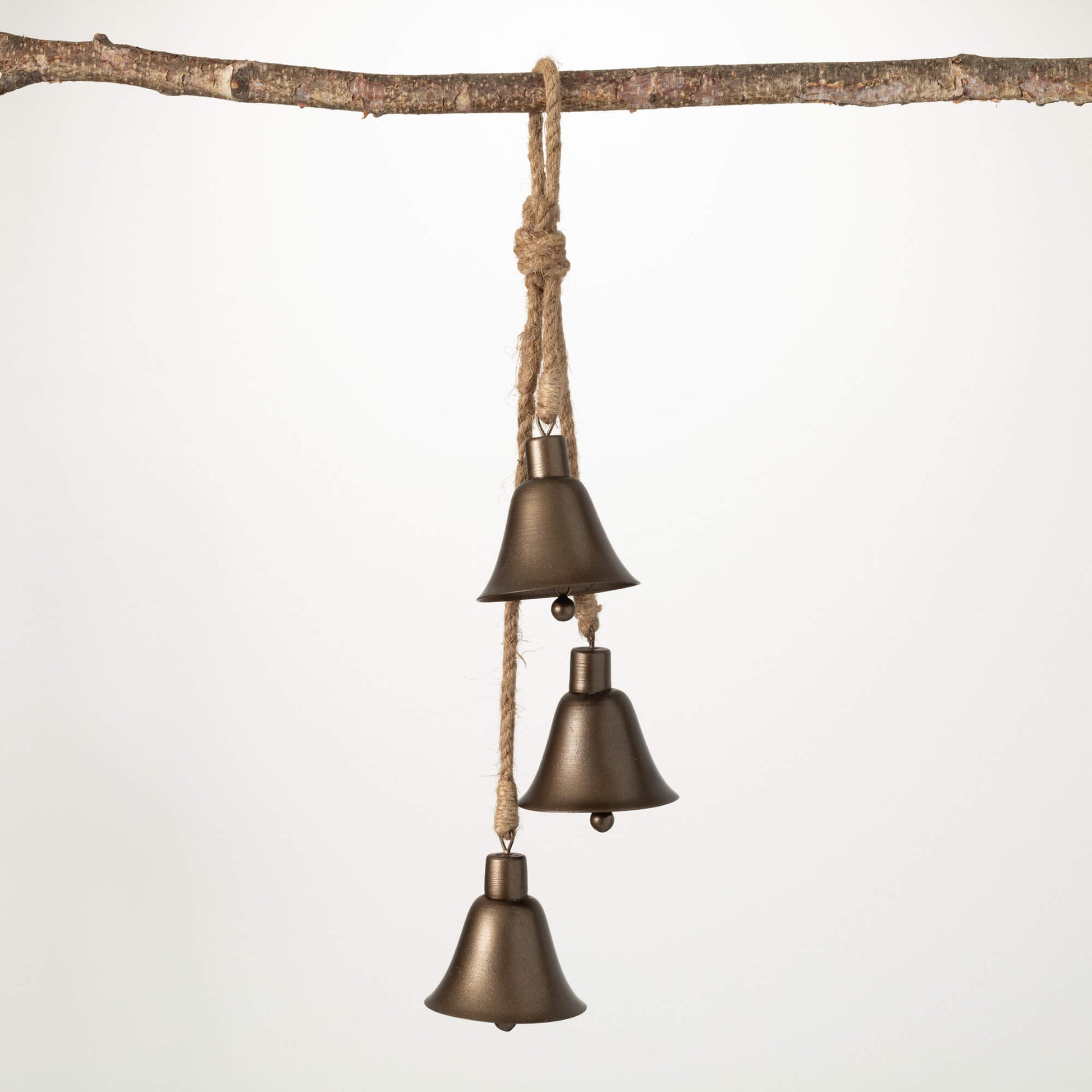 bronze christmas bell swag displayed hanging from a branch against a white background