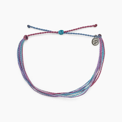 Pura Vida multi strand corded bracelet in varying shades of blue, pink, purple, cream with a Pura Vida logo charm