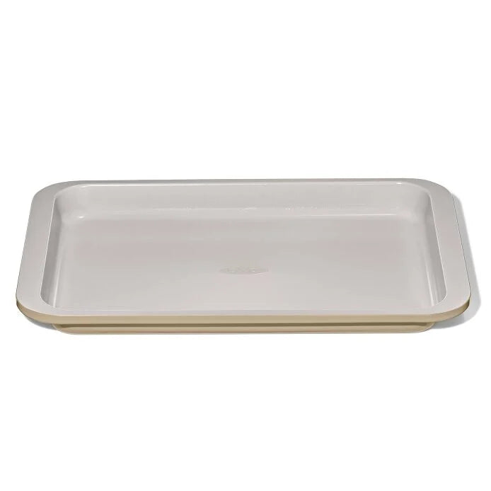 OXO metal and ceramic jellyroll pan That is beige on the outside and lighter beige on the inside