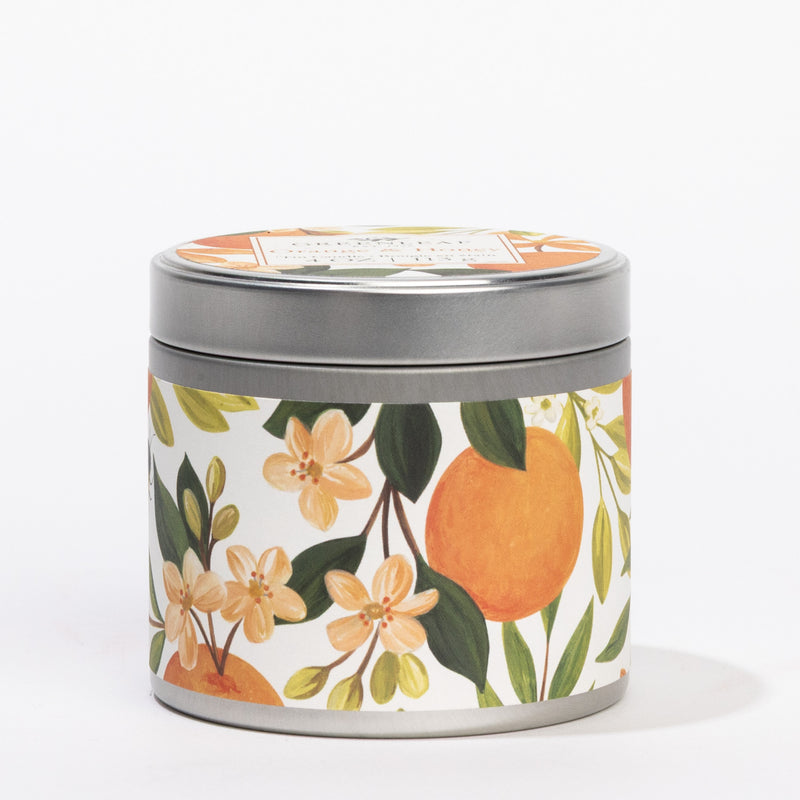 front view of Orange & Honey Tin Candle with its lid on