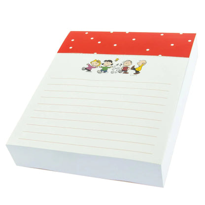 side view of lined notepad with peanuts characters at the top