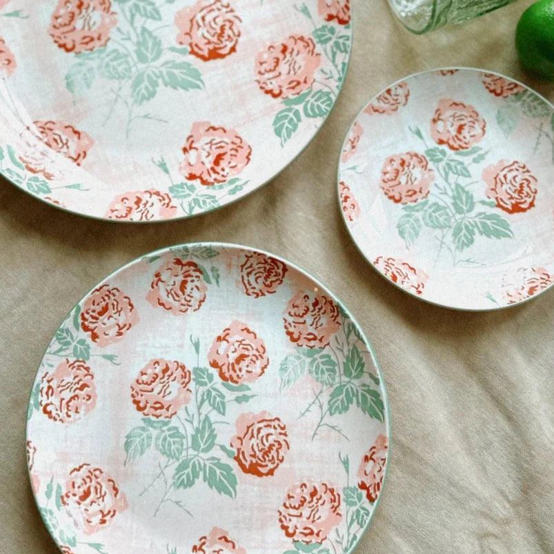 claudette plates arranged ona table with a taupe tablecloth.