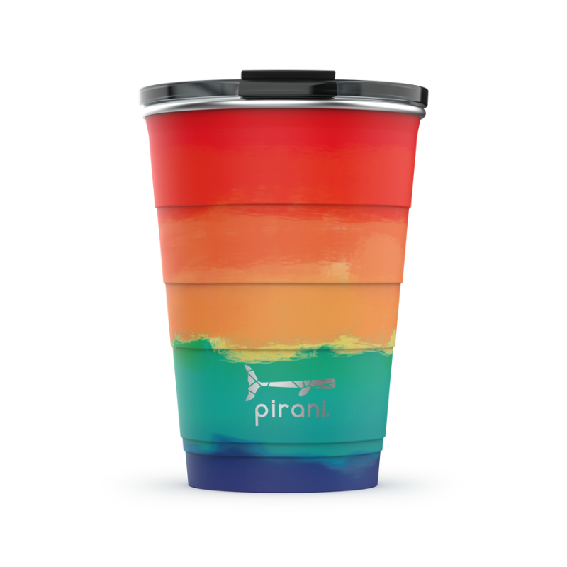 sunset tumbler with silver pirani logo near the bottom of cup and a lid on it, ombre color pallet from bottom to top is blues, greens, oranges, and red.