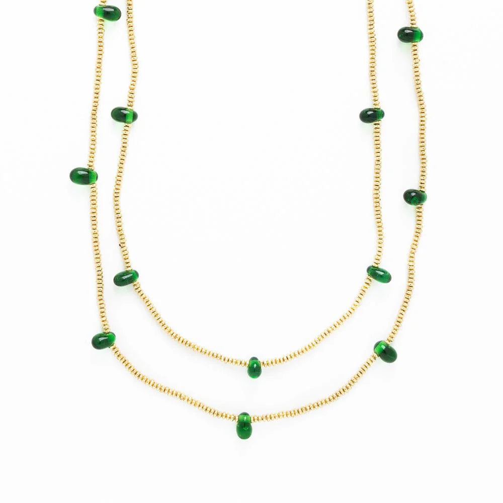 close-up of gold necklace with green beads