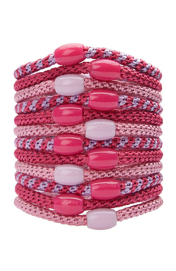 stack of power pink ponytail holders each with coordinating oval bead on a white background.