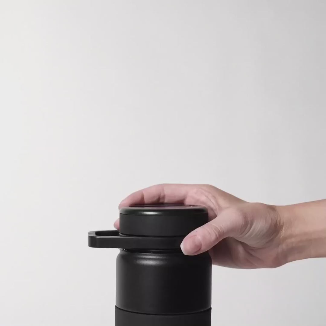 video without sound of a hand lifting the lid with the straw off the rotera water bottle