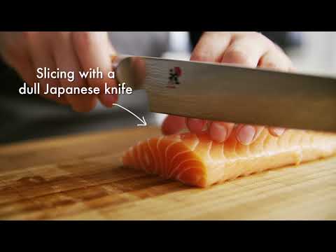 video of person cutting tomato with dull knife, then sharpening knife with v edge sharpener and cutting tomato with sharp knife
