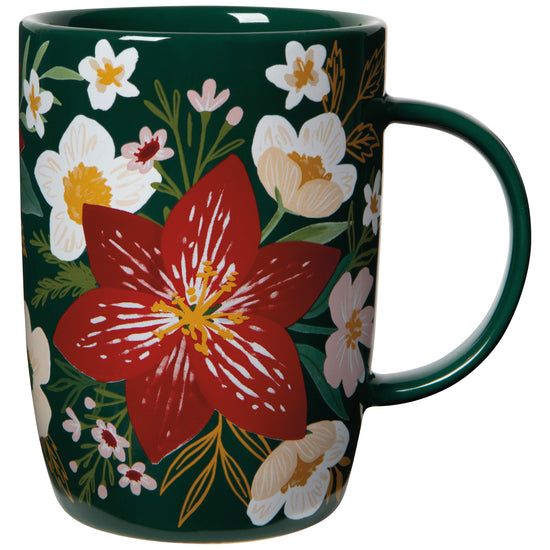 A green porcelain mug with a floral pattern, featuring prominent red and white flowers.