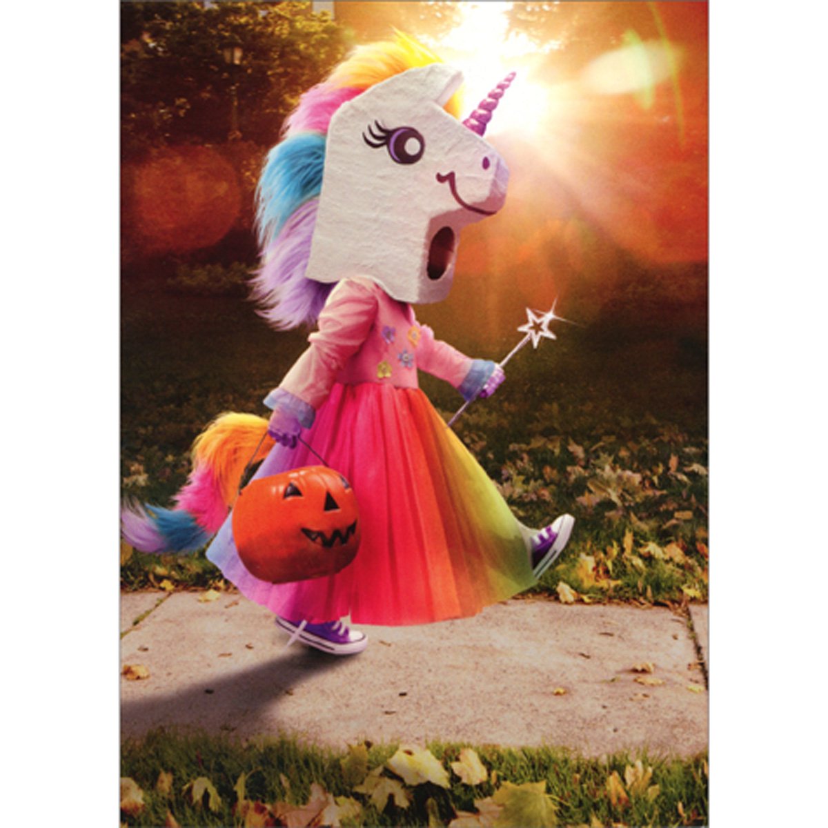front of card has a little girl wearing a rainbow dress and unicorn head while holding a pumpkin full of candy